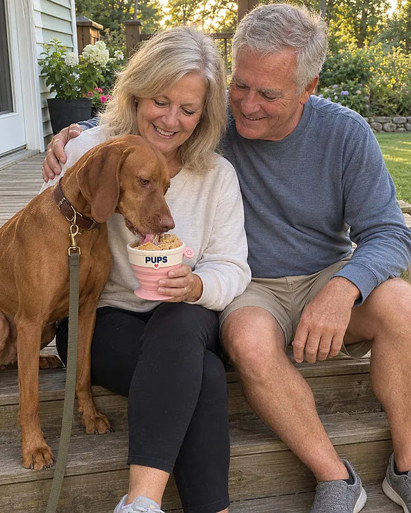 A couple on the porch while their dog licks a PUPS cup